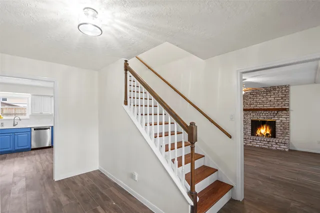 a view of an entryway with wooden floor and a fire place
