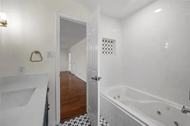 a bathroom with a bathtub and shower