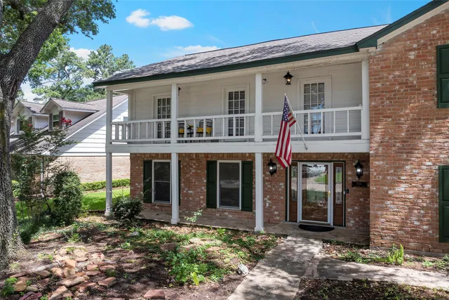 a view of a house with brick walls