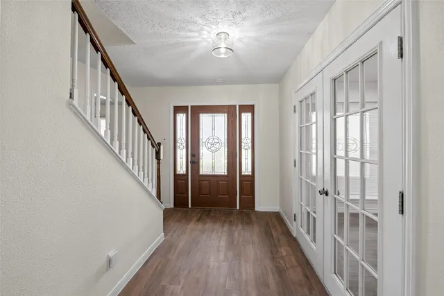 a view of an entryway with wooden floor