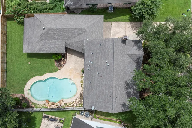 an aerial view of a house with garden space pool seating area and yard