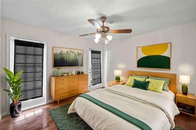 a bedroom with a bed and a potted plant