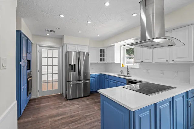 a kitchen with refrigerator cabinets and wooden floor