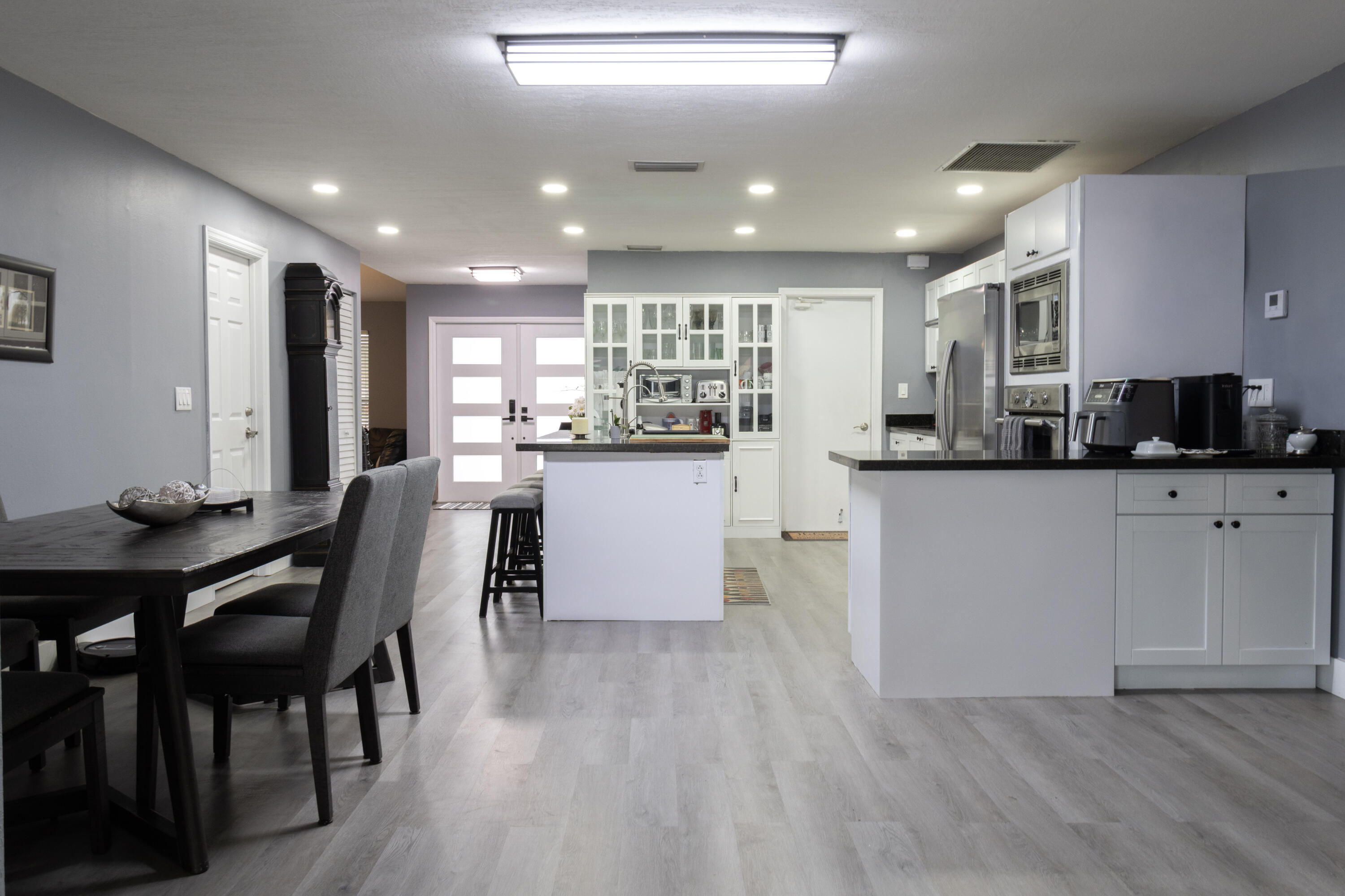 23287 Southwest 60th Avenue Boca Raton, FL 33428 - Photo 11 of 43 a kitchen with granite countertop cabinets a dining table and chairs