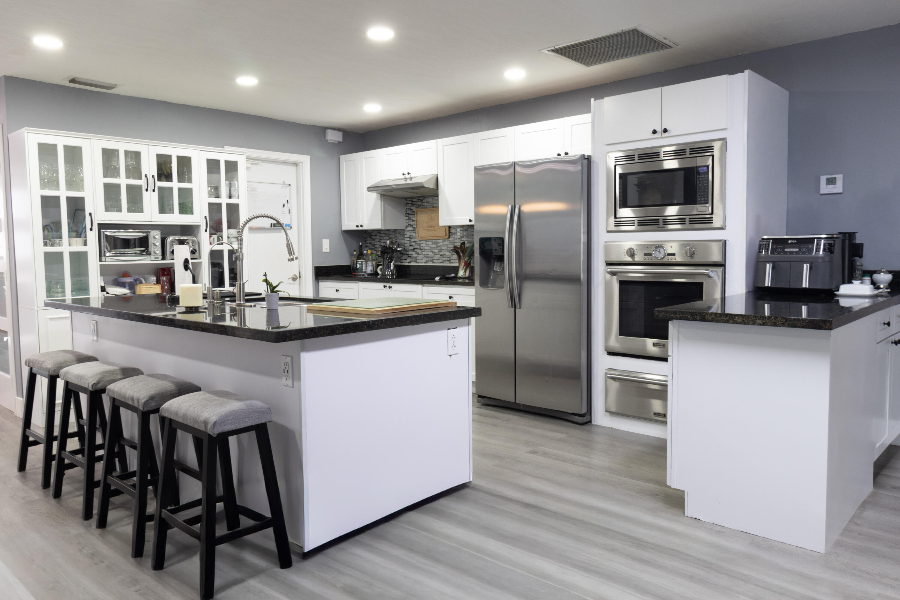 23287 Southwest 60th Avenue Boca Raton, FL 33428 - Photo 12 of 43 a kitchen with stainless steel appliances granite countertop a refrigerator a stove and a microwave