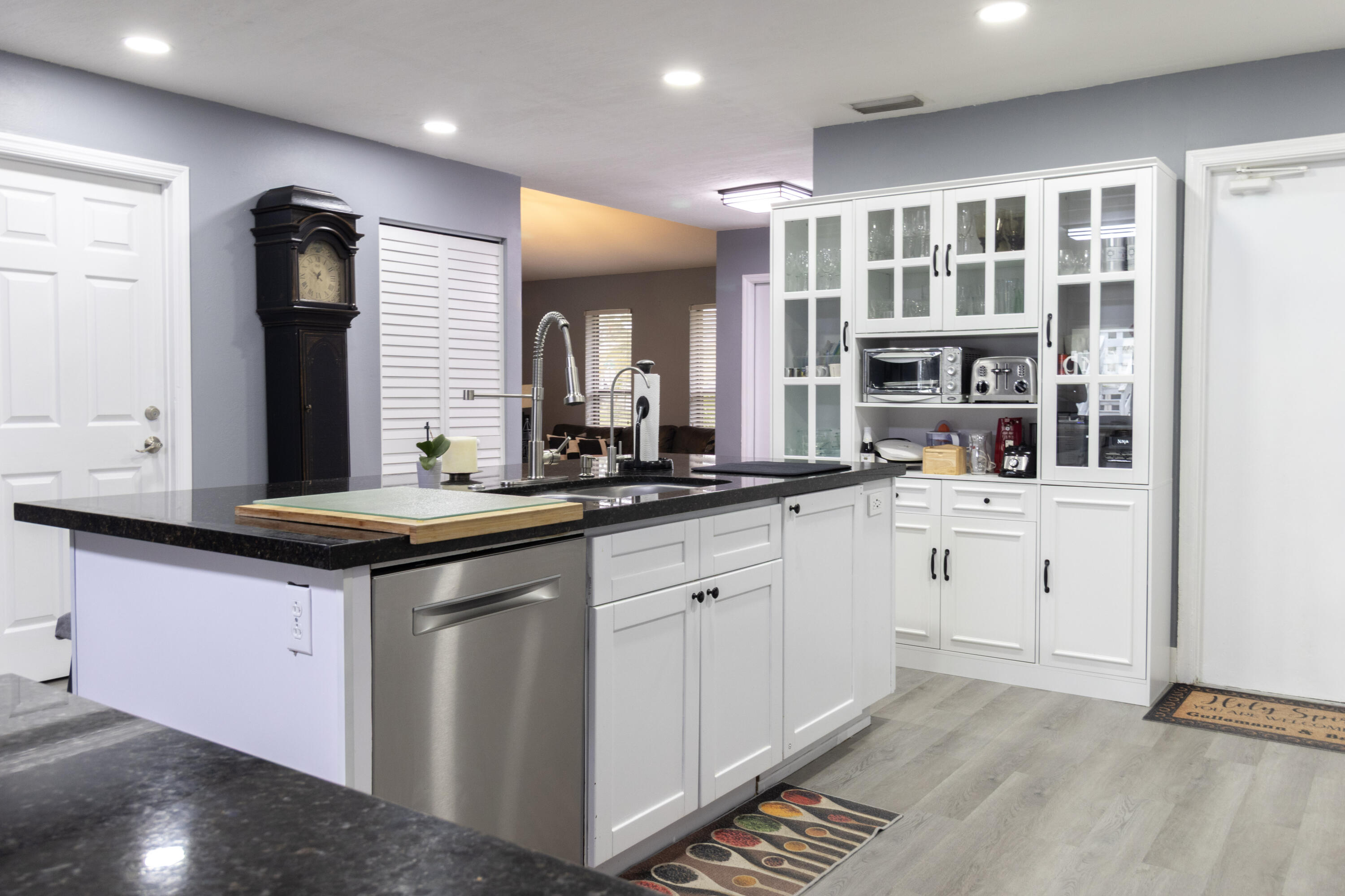 23287 Southwest 60th Avenue Boca Raton, FL 33428 - Photo 13 of 43 a kitchen with granite countertop a sink and cabinets