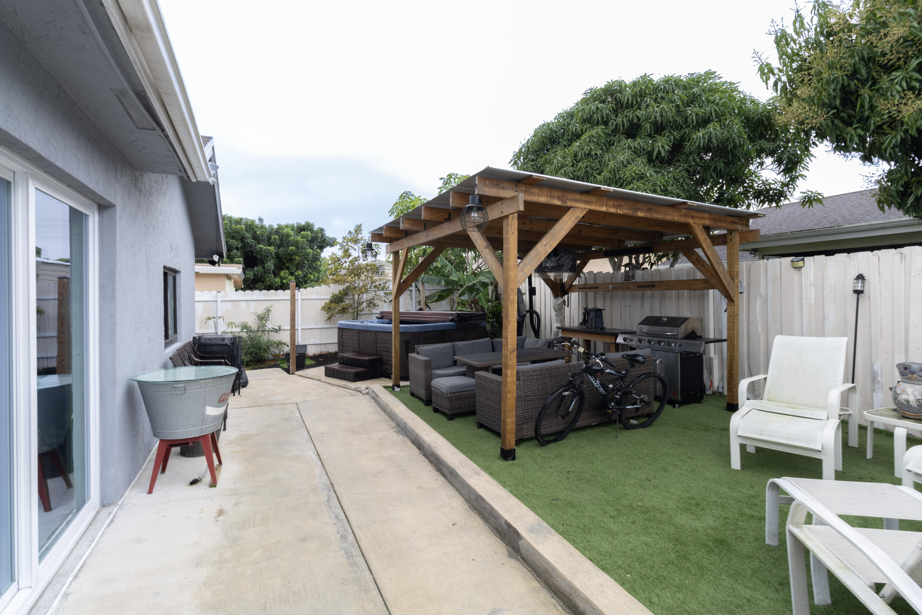 23287 Southwest 60th Avenue Boca Raton, FL 33428 - Photo 18 of 43 a view of backyard with a patio and a garden
