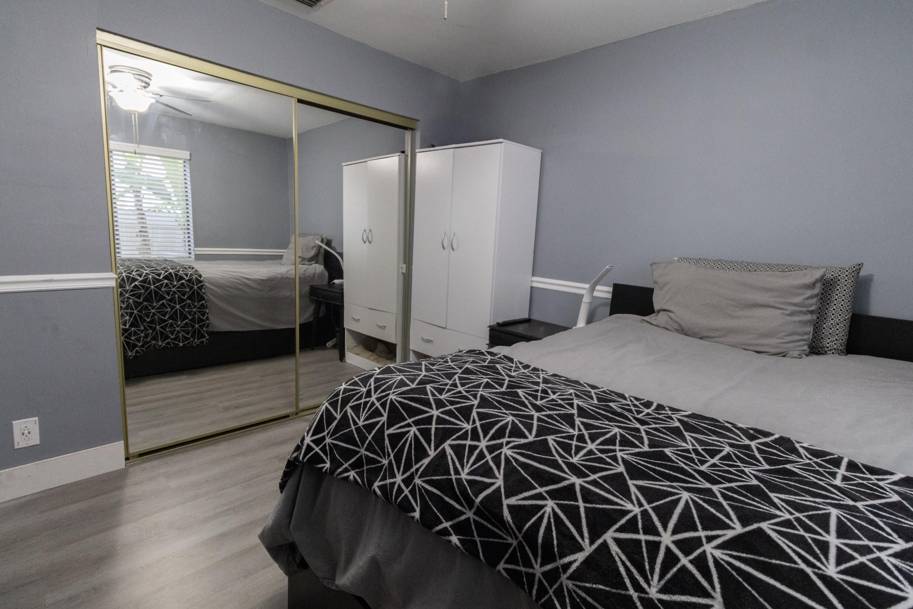 23287 Southwest 60th Avenue Boca Raton, FL 33428 - Photo 21 of 43 a bedroom with a bed and a walk in closet