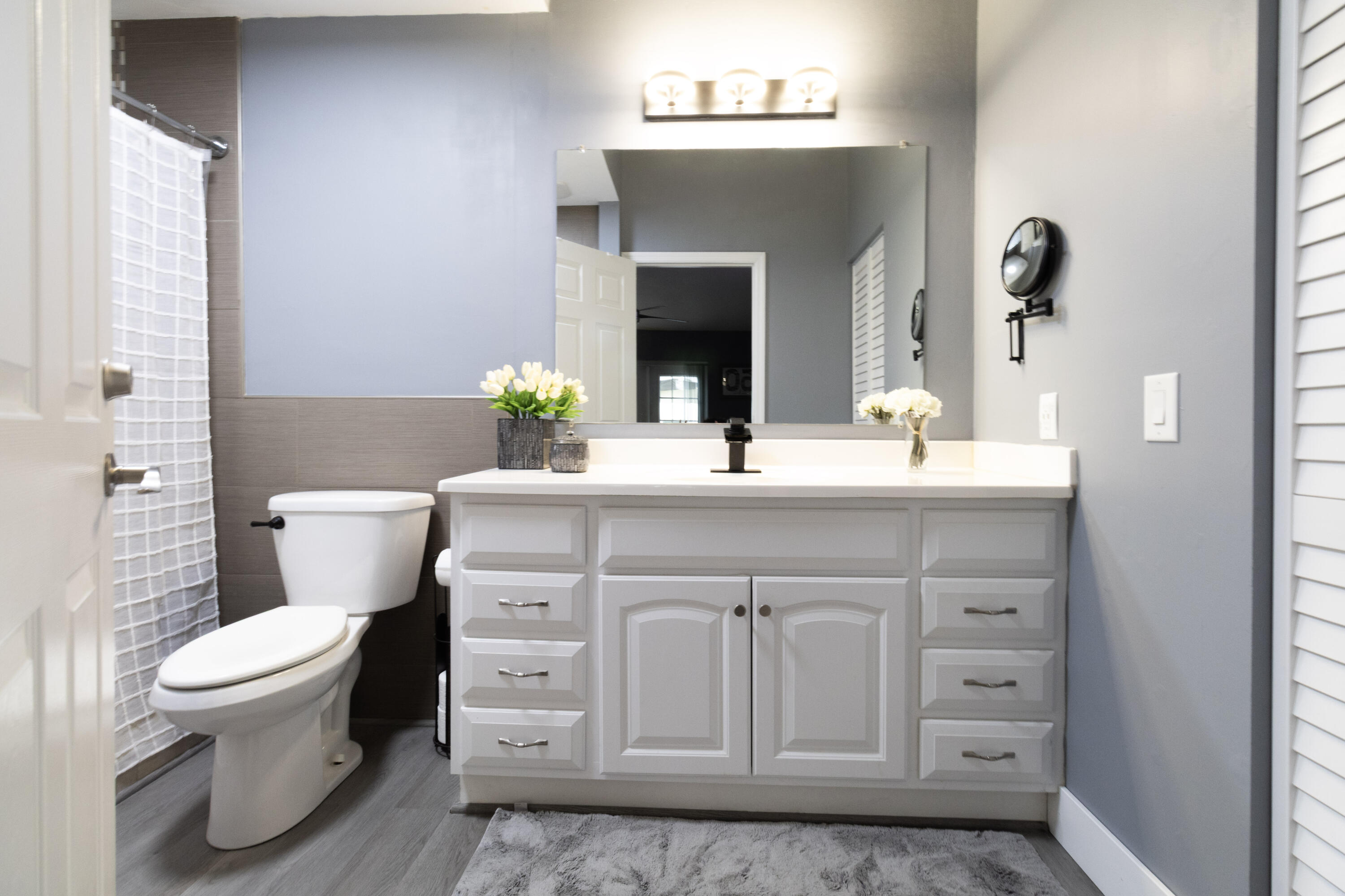 23287 Southwest 60th Avenue Boca Raton, FL 33428 - Photo 26 of 43 a bathroom with a sink toilet and mirror