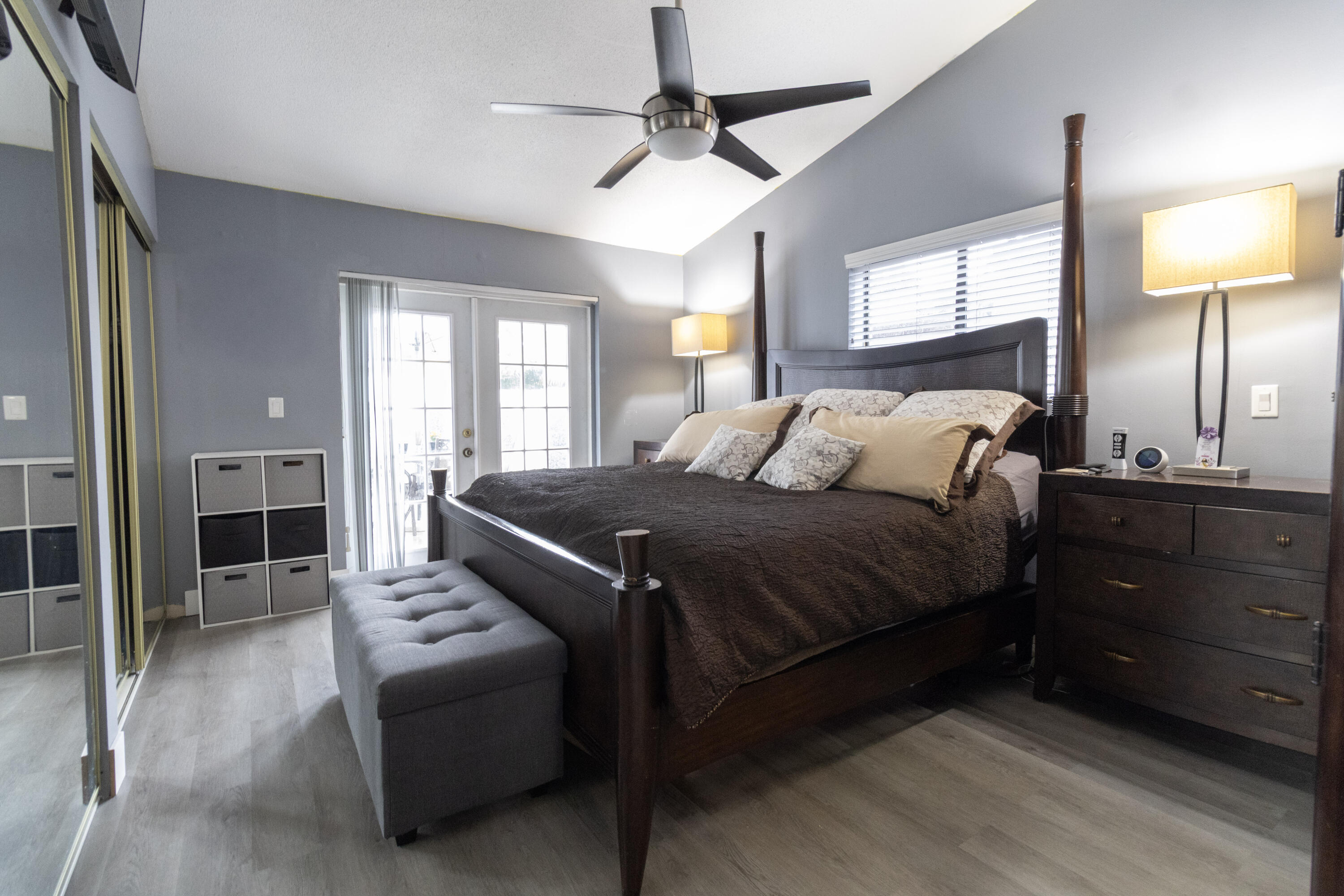 23287 Southwest 60th Avenue Boca Raton, FL 33428 - Photo 28 of 43 a spacious bedroom with a bed and a chandelier