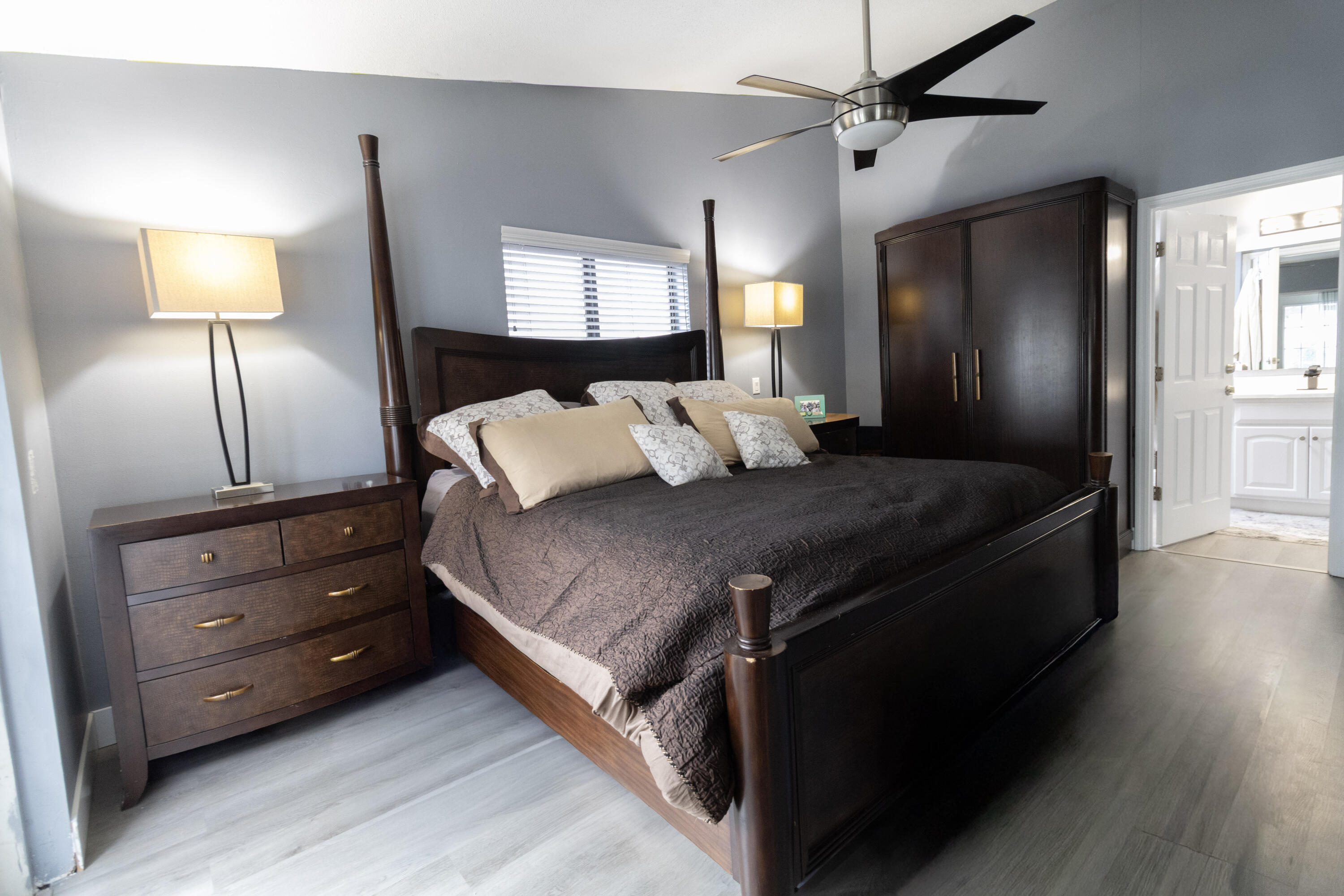 23287 Southwest 60th Avenue Boca Raton, FL 33428 - Photo 29 of 43 a bedroom with a bed and a lamp