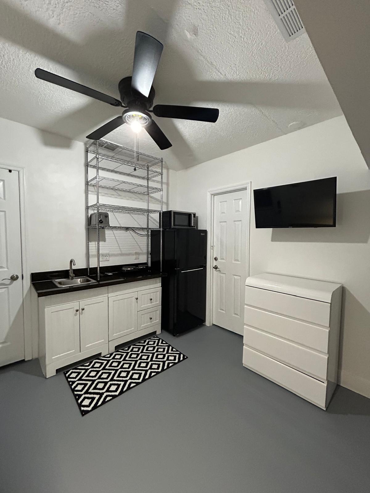 23287 Southwest 60th Avenue Boca Raton, FL 33428 - Photo 38 of 43 a kitchen with stainless steel appliances kitchen island granite countertop a refrigerator and a stove