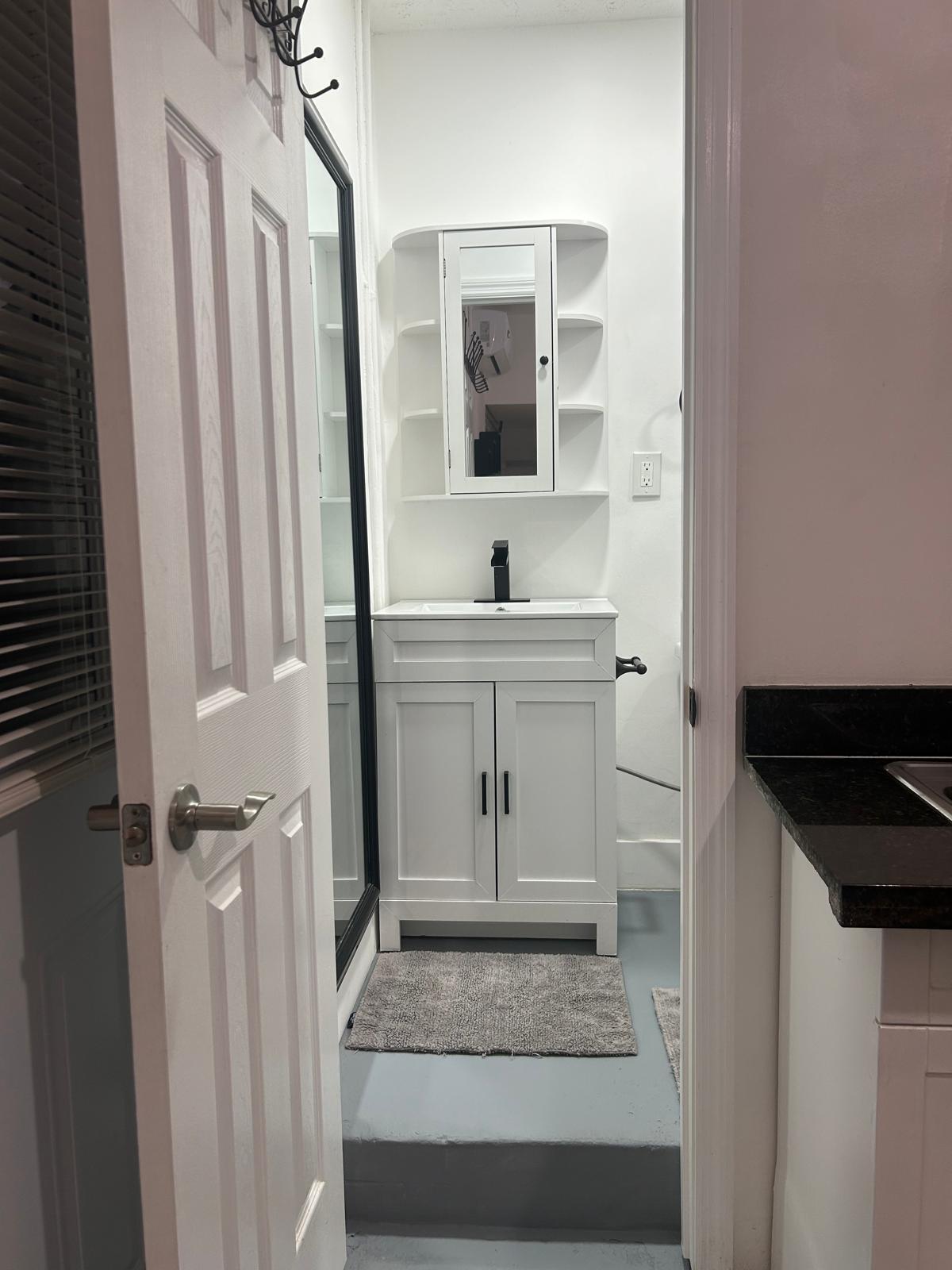 23287 Southwest 60th Avenue Boca Raton, FL 33428 - Photo 43 of 43 a bathroom with a sink and a mirror