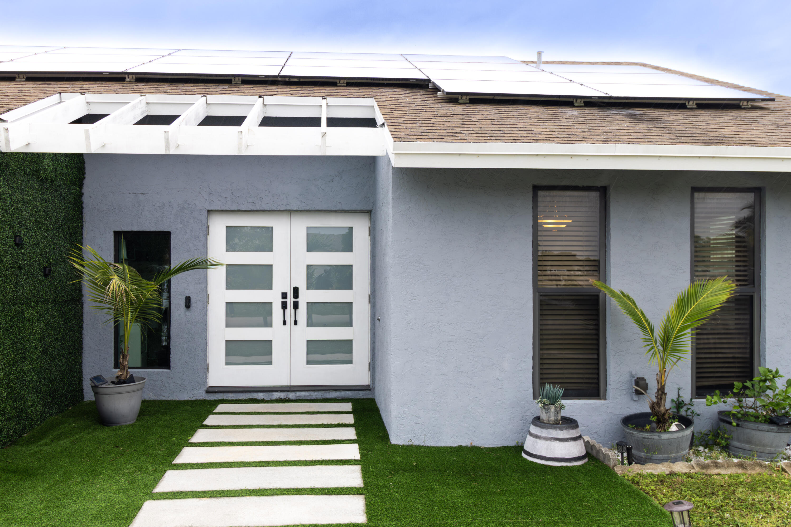 23287 Southwest 60th Avenue Boca Raton, FL 33428 - Photo 5 of 43 a front view of a house with garden