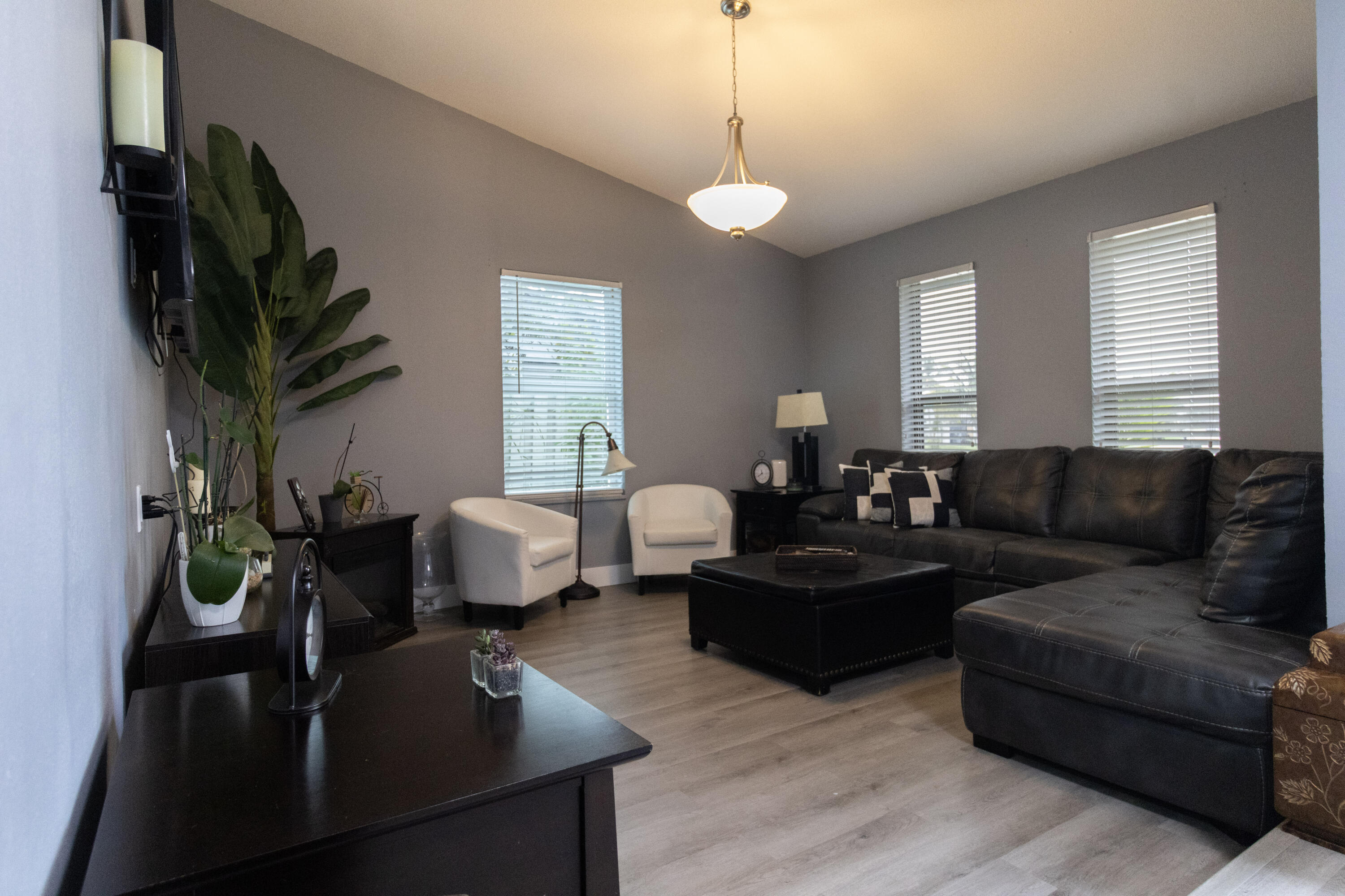 23287 Southwest 60th Avenue Boca Raton, FL 33428 - Photo 7 of 43 a living room with furniture potted plant and a window
