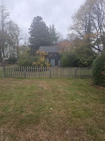 a view of yard with large trees