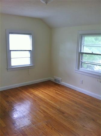 17 Dana Street Springfield, MA 01104 - Photo 5 of 12 an empty room with wooden floor and windows
