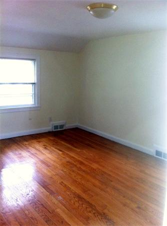 17 Dana Street Springfield, MA 01104 - Photo 8 of 12 an empty room with wooden floor and windows