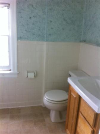 17 Dana Street Springfield, MA 01104 - Photo 9 of 12 a white toilet sitting next to a window