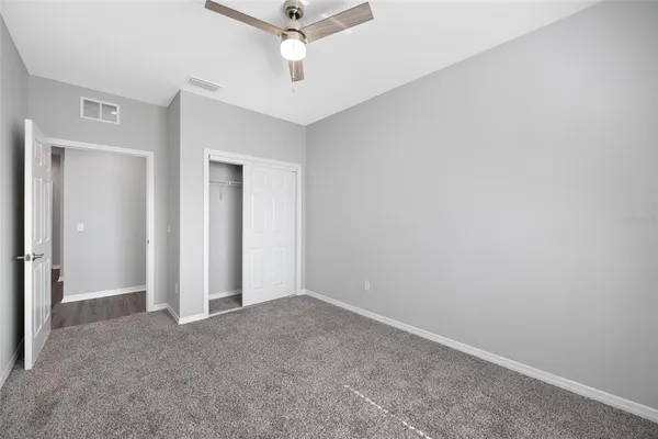 an empty room with a empty space and a ceiling fan