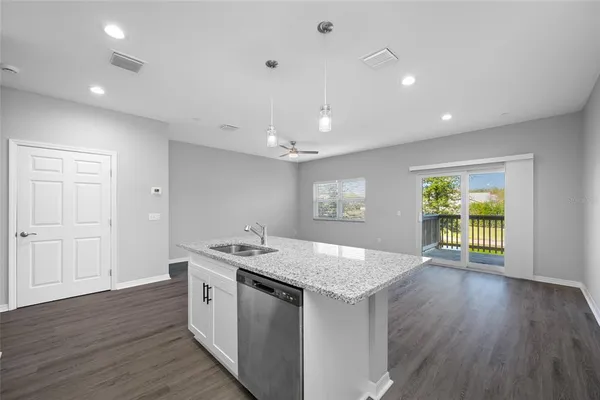 an open kitchen with a sink and dish washer