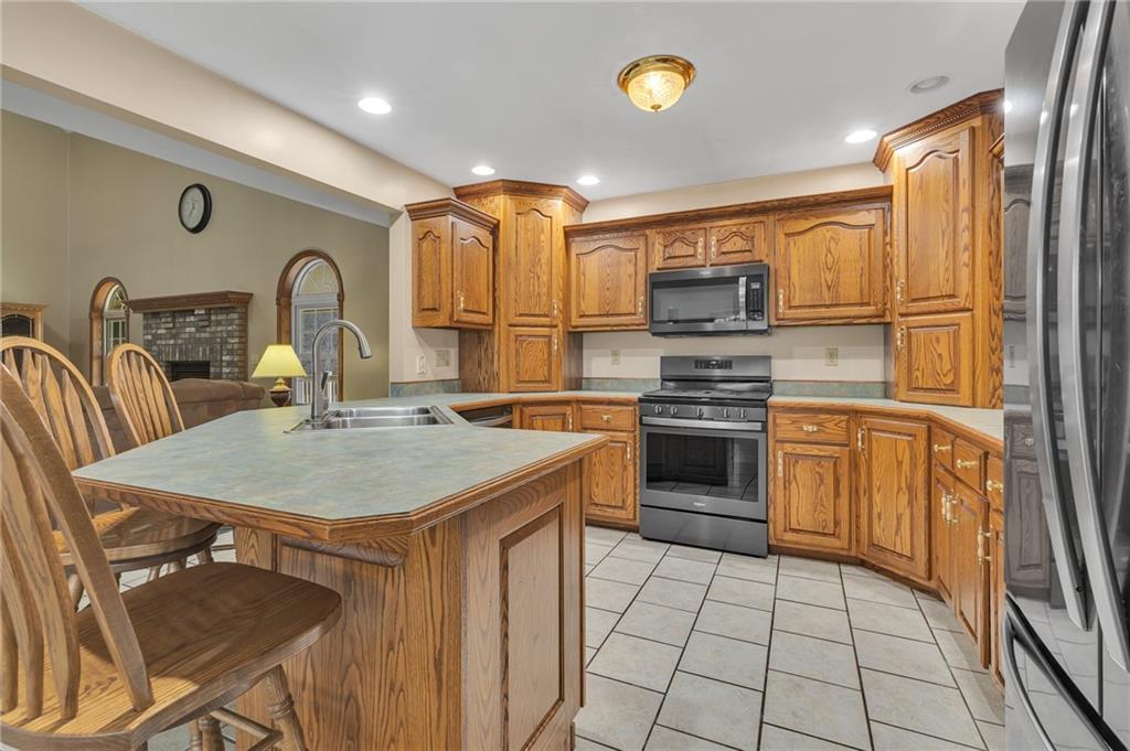 824 Old Millcreek Road Hookstown, PA 15050 - Photo 11 of 35 a kitchen with stainless steel appliances granite countertop a stove a sink and a refrigerator
