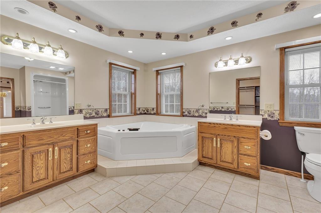 824 Old Millcreek Road Hookstown, PA 15050 - Photo 20 of 35 a spacious bathroom with a granite countertop tub sink and a mirror