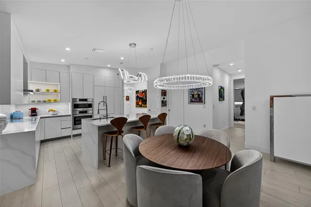 a large kitchen with a table and chairs