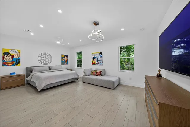 a bedroom with a bed and a large window