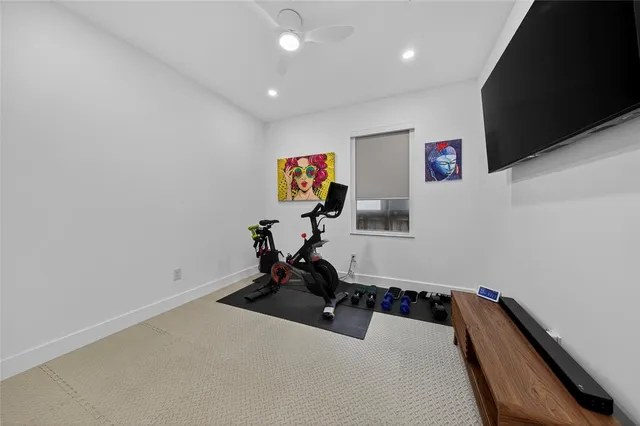 a room with gym equipment and view of living room