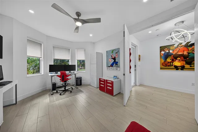 an empty room with wooden floor and window