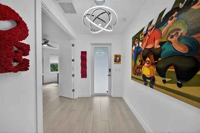 a living room with hardwood floor and a large window