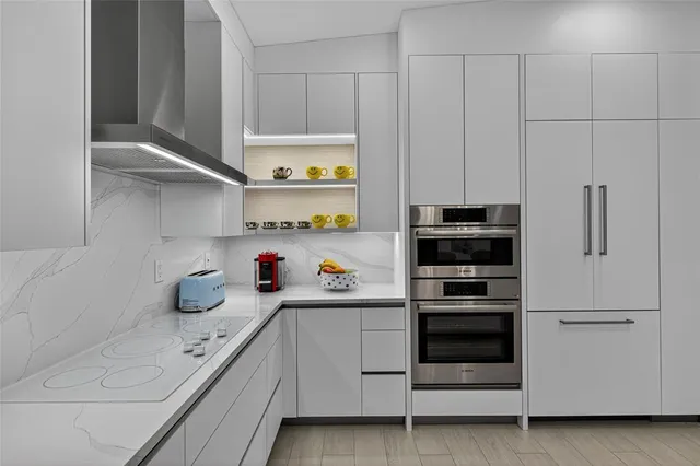 a kitchen with stainless steel appliances a white stove and cabinets