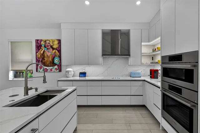 a kitchen with a sink and cabinets