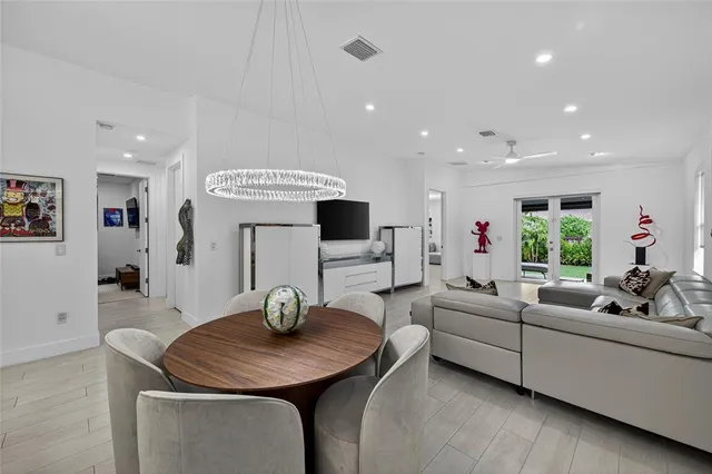 a living room with furniture a flat screen tv and a large window