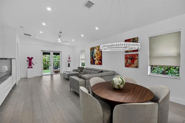 a living room with furniture and flowers