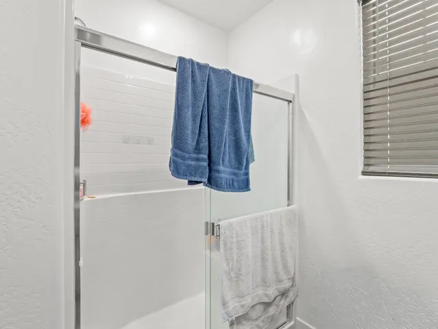 a bathroom with a shower and a window