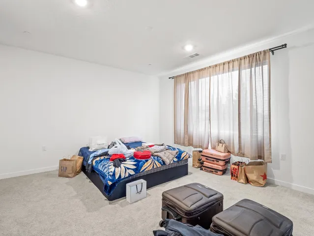 a bedroom with furniture and a window