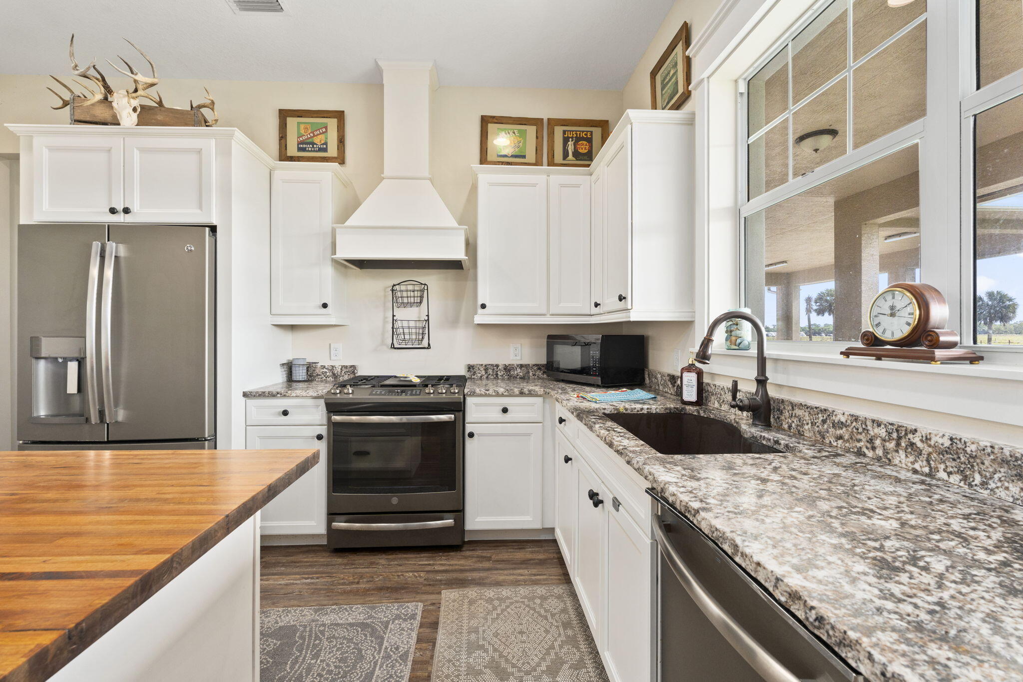 1720 South Brocksmith Road Fort Pierce, FL 34945 - Photo 16 of 53 a kitchen with stainless steel appliances granite countertop a sink stove and refrigerator