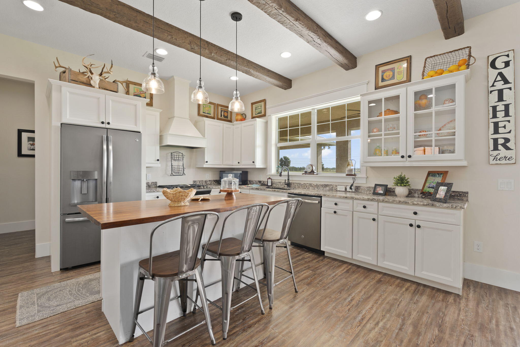 1720 South Brocksmith Road Fort Pierce, FL 34945 - Photo 17 of 53 a kitchen with stainless steel appliances granite countertop a dining table chairs refrigerator and sink