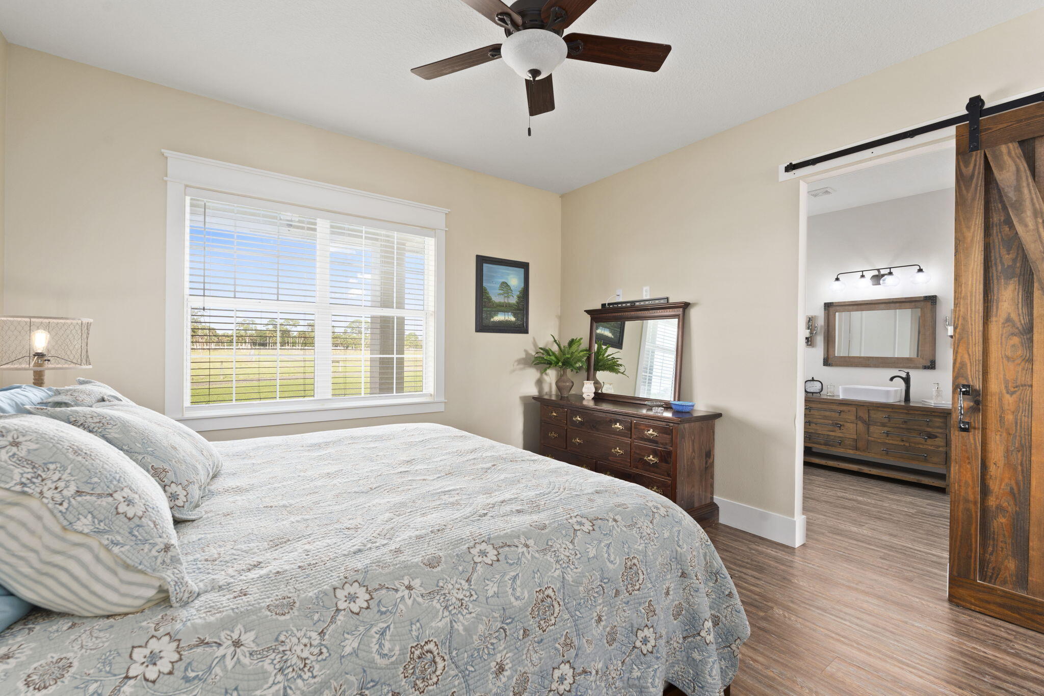 1720 South Brocksmith Road Fort Pierce, FL 34945 - Photo 24 of 53 a bedroom with a bed and wooden floor