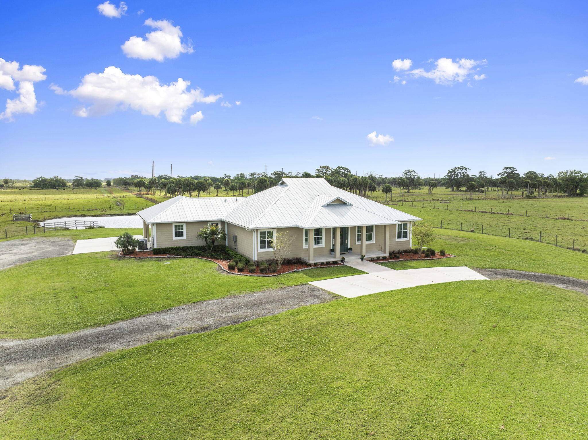 1720 South Brocksmith Road Fort Pierce, FL 34945 - Photo 3 of 53 a view of a house with a yard and lake view