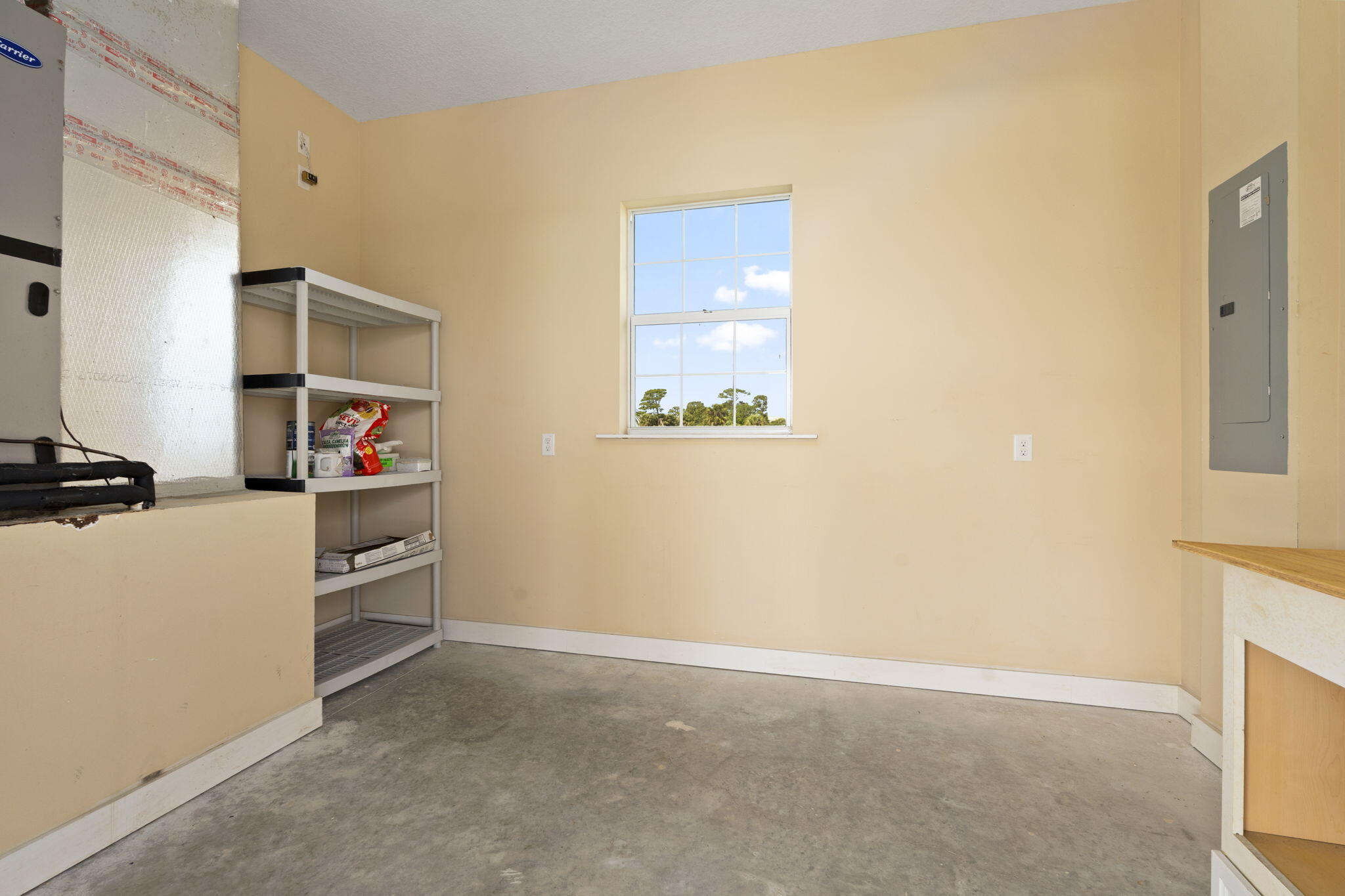 1720 South Brocksmith Road Fort Pierce, FL 34945 - Photo 38 of 53 a room with a white bed and a window