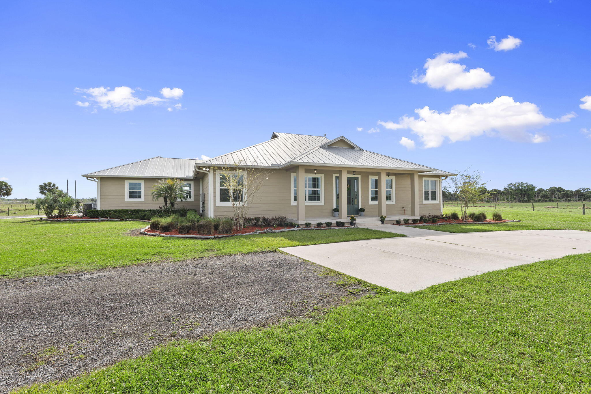 1720 South Brocksmith Road Fort Pierce, FL 34945 - Photo 4 of 53 a front view of a house with a yard and garage