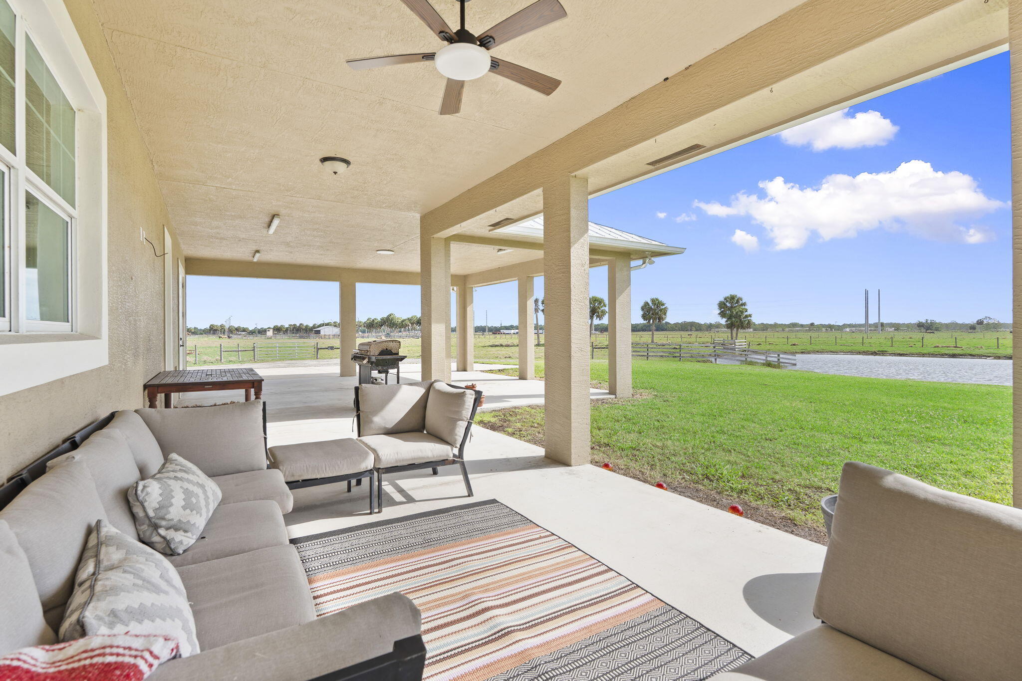 1720 South Brocksmith Road Fort Pierce, FL 34945 - Photo 40 of 53 a living room with furniture and a large window