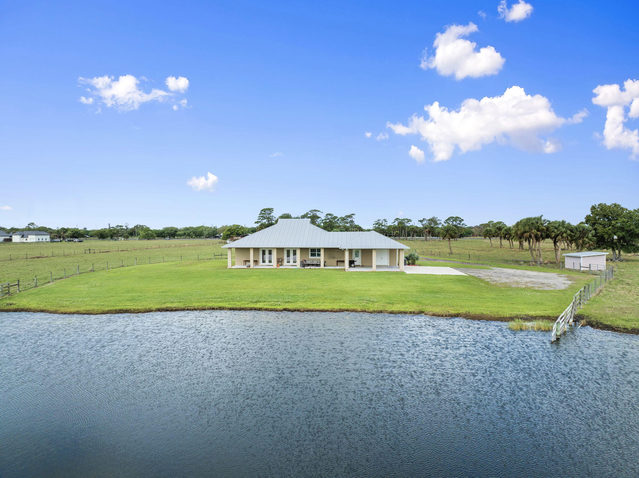 1720 South Brocksmith Road Fort Pierce, FL 34945 - Photo 45 of 53 a view of a house with a big yard and a large tree