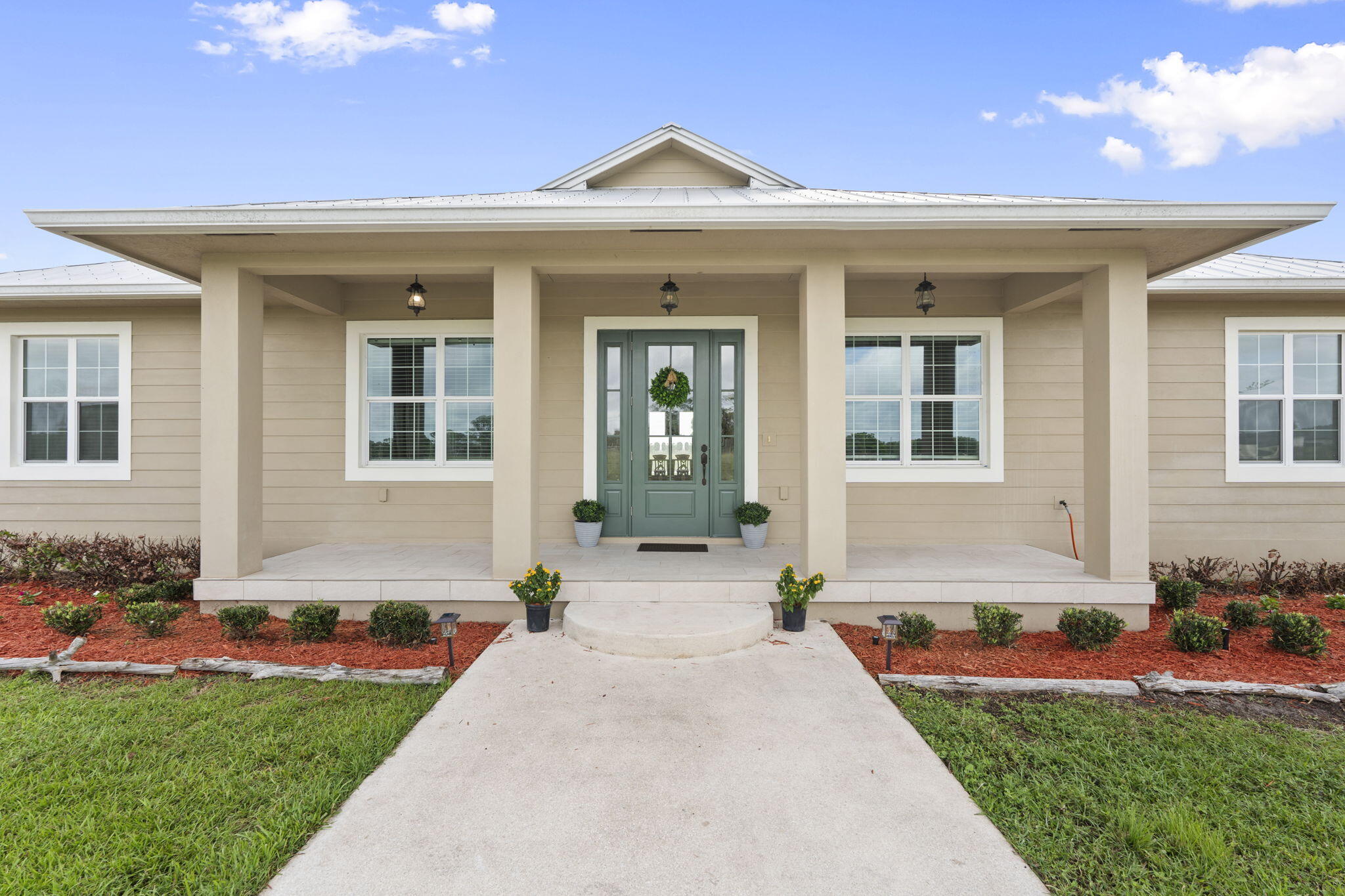 1720 South Brocksmith Road Fort Pierce, FL 34945 - Photo 6 of 53 a front view of a house with a yard