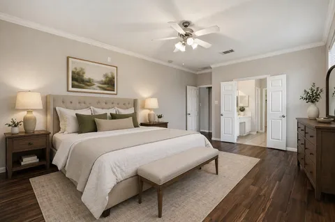 a spacious bedroom with a bed and a chandelier