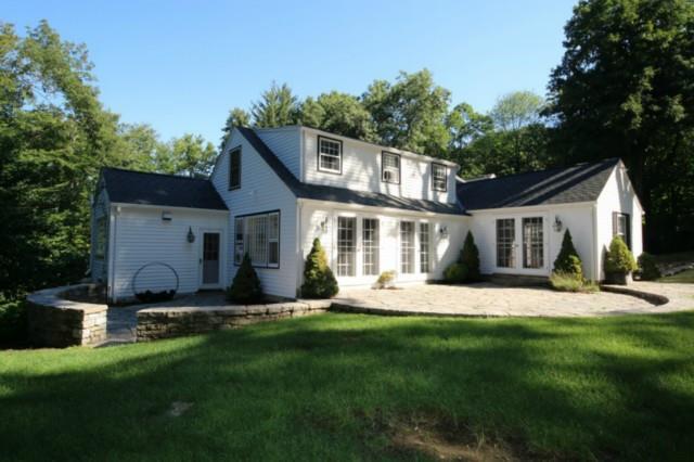 8 Fanton Hill Road Weston, CT 06883 - Photo 1 of 1 a front view of house with a garden and yard