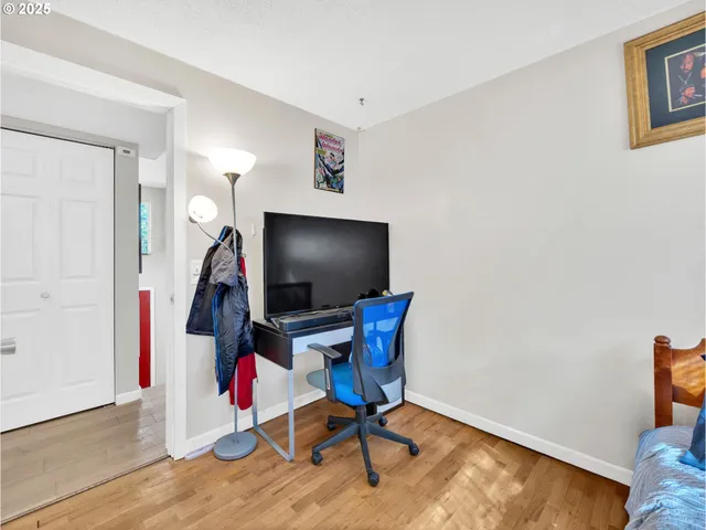 a view of a workspace with furniture and a flat screen tv